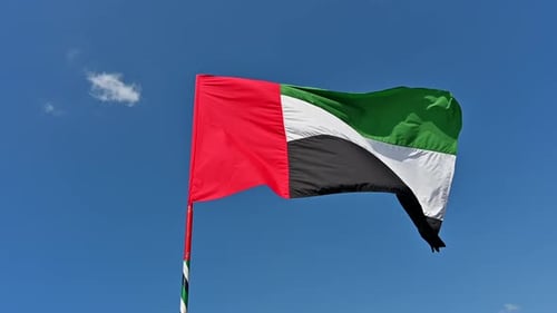 4k Footage: National Flag of United Arab Emirates (UAE) on a Pole Waving in Wind against Clear Blue