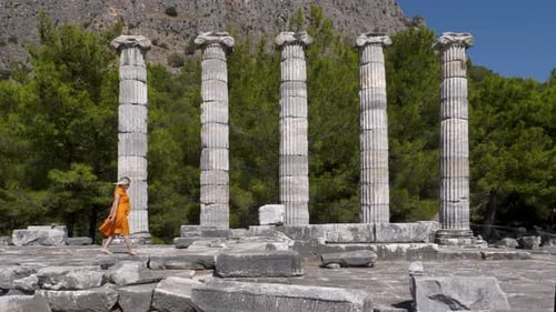 Woman Walking Among Historical Ruins