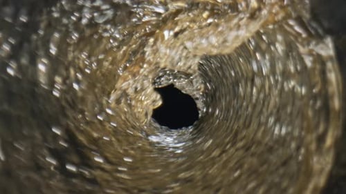 Liquid Swirling and Rushing Down a Drain