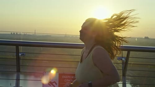 Sports Girl Jogging at Dawn in the City