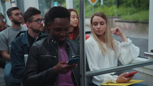 Passengers on a Bus Engrossed in Smartphones Reflect Solitude