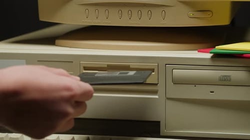 Using Diskette FDD for Old Computer Closeup Hand Inserting and Ejecting Floppy Disk Into Vintage PC
