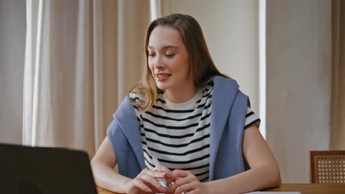 Young Woman Working at Home on Laptop