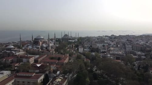 Drone shot of Hagia Sophia and the Blue Mosque in Istanbul - drone is circling around from far. Snip