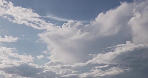 Clouds Moving Gently Across a Blue Sky