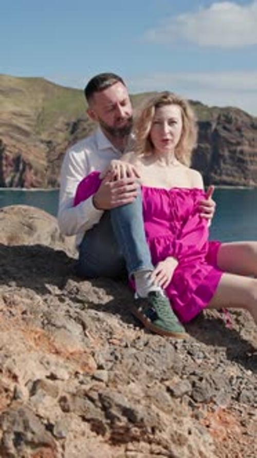 Couple Enjoying Romantic Moments on a Cliff Overlooking the Ocean