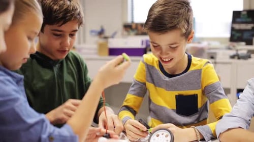 Children Building Robot Together in Classroom Setting