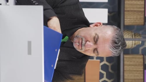 Man Taking Notes at His Computer in Office