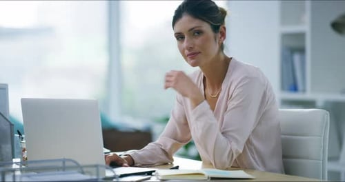 4k video footage of an attractive young businesswoman working on her laptop in the office