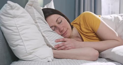 Woman Relaxing Peacefully in Bed
