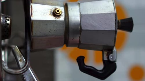 Close up of piezoelectric gas lighter turning on gas stove for traditional Italian Neapolitan coffee