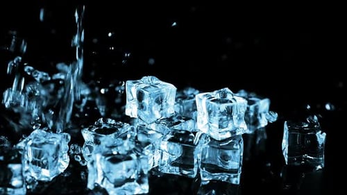 A stream of water falls on ice cubes on a black background. Slow motion.