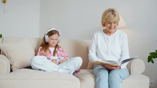 Grandmother and Granddaughter Relaxing Together on Couch