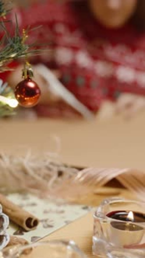 Woman Crafts Christmas Decorations in Festive Home Scene