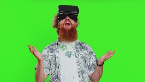 Man Experiences Virtual Reality on Green Screen