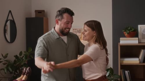 Happy Couple Dancing Together in Living Room