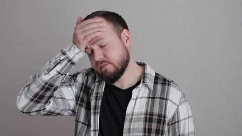 Adult Man Experiencing Headache Indoors