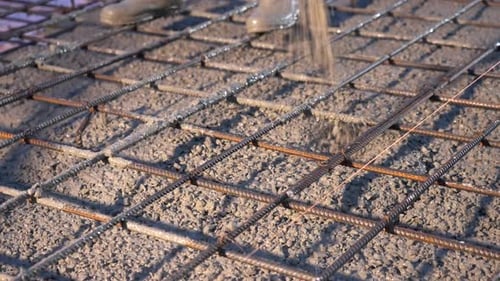 Concrete Being Poured Onto Rebar Foundation at Construction Site