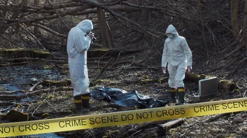 Forensic Specialist Working in the Forest Police Criminalists Collecting Evidence and Making
