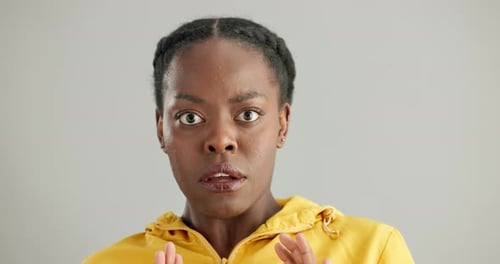 Black woman, face with fear or scared in studio, shock or surprise for news