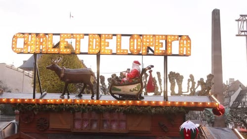 santa riding his sleigh with neon signage at Festive Christmas market in Strasbourg, France Europe