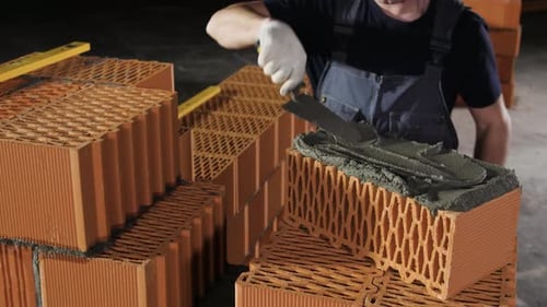 Construction Worker Applying Mortar on Brick in Six Steps