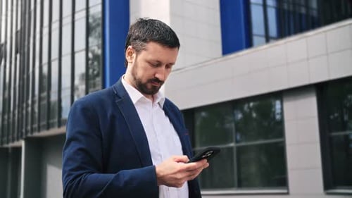 Successful Business Man in Suit Chatting Smartphone Pensive Face Expression Downtown Office Street