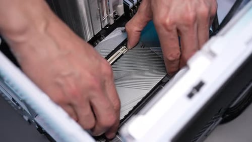 Top View of Unrecognizable Computer Repair Technician Male Removing Cover on Motherboard to Install