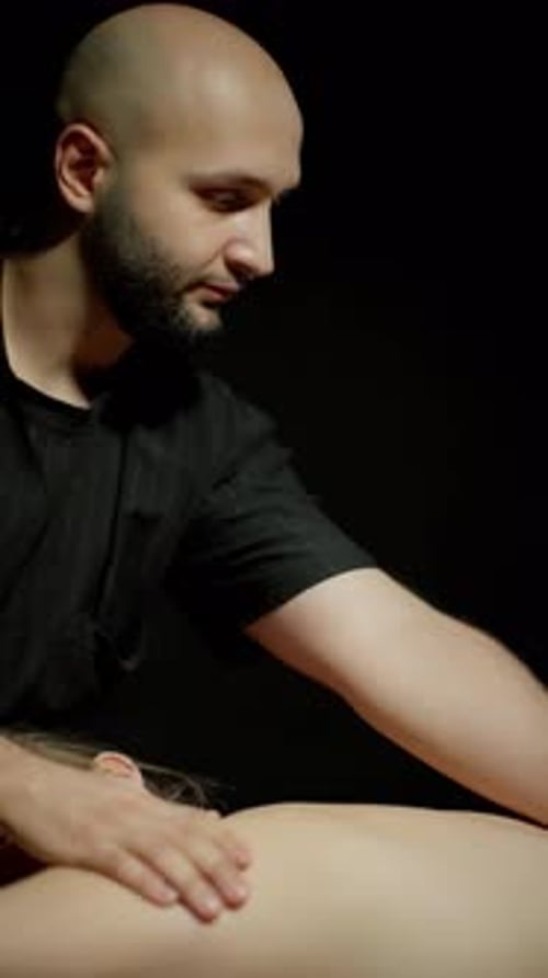 Man Giving Relaxing Back Massage to Woman