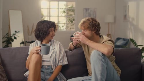 Young Friends Conversing and Drinking Coffee at Home