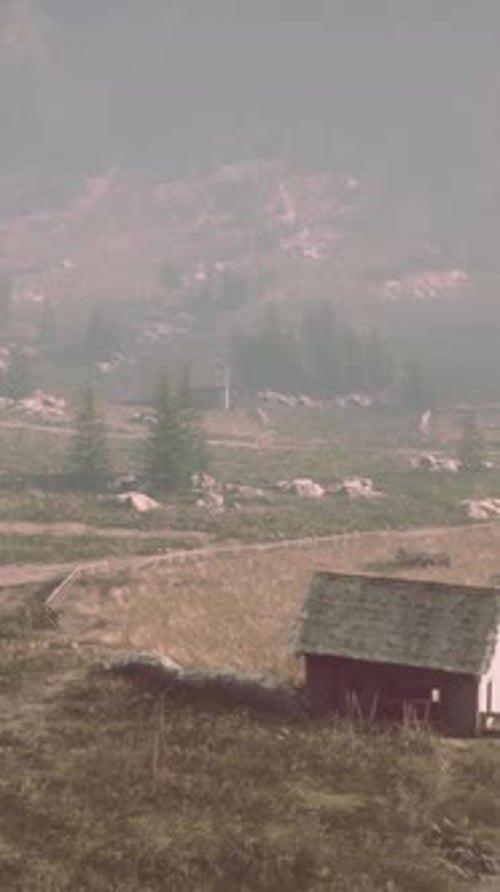 Old Wooden Village on the Rocky Mountain Background
