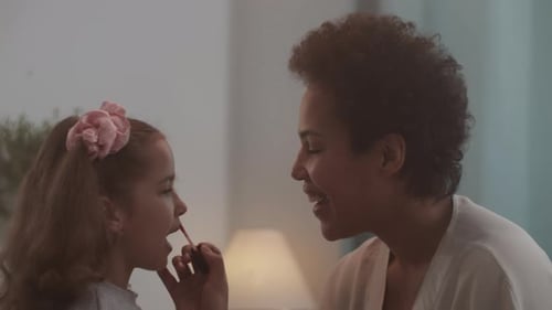 Little Girl Having Lip Gloss Applied by Adult