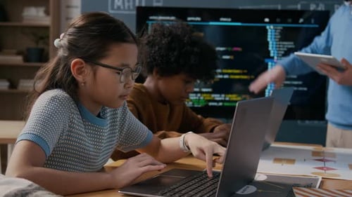 Diversos escolares escriben Código de Computadora en Computadoras Portátiles durante la Lección