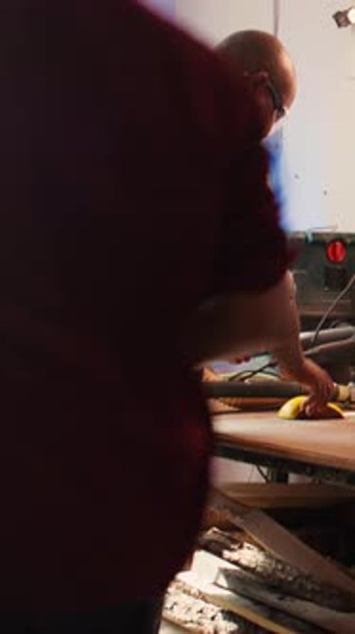 Vertical Video Artisan in Studio Using Sandpaper for Smoothing Wooden Surface