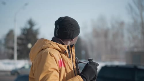 Wildlife Photographer Walking Urban Street Scanning Scene Through Viewfinder