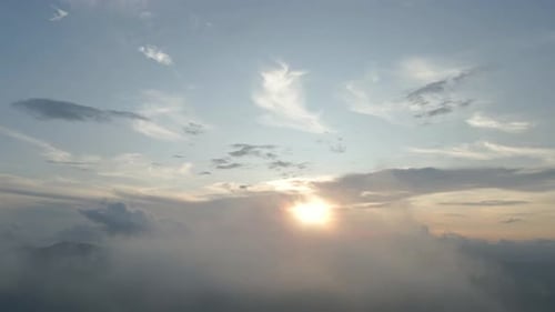 sunset through the clouds. Flying heavenly beautiful sunny cloudscape. Amazing golden fluffy.