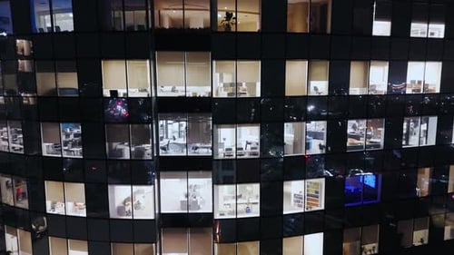 Cinematic Drone View Night Windows of the Skyscraper Office Corporate Building