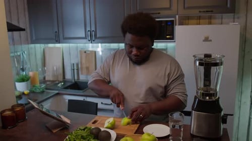 Young Adult Cuts Apple for a Smoothie