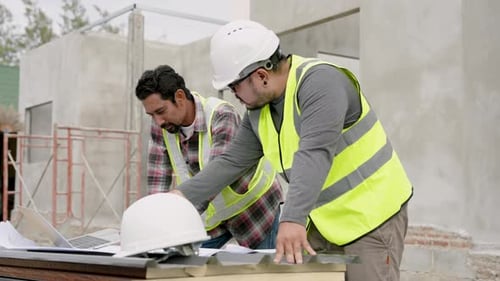 Asian male engineer and construction foreman Wear reflective clothing Wear a safety hat Standing and