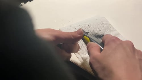 Hands Sharpening Lead with Utility Knife Close Up