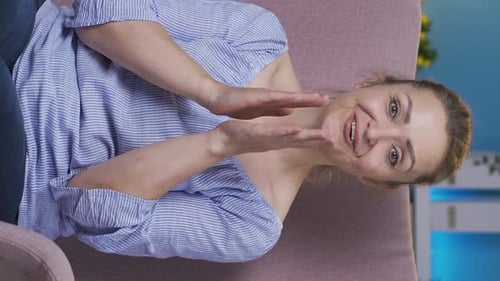 Smiling Woman Gesturing Positively in Vertical Video
