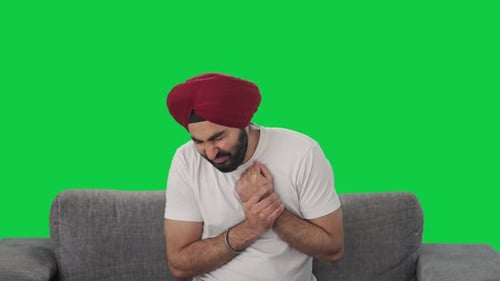 Sikh Indian man suffering from hand pain Green screen
