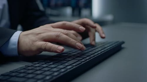 Close-up on the Man's in a Suit Hands Typing on a Keyboard.