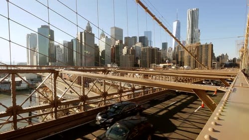 Sunny Day View of NYC Skyline From Brooklyn Bridge with Iconic Buildings and Steel Cables