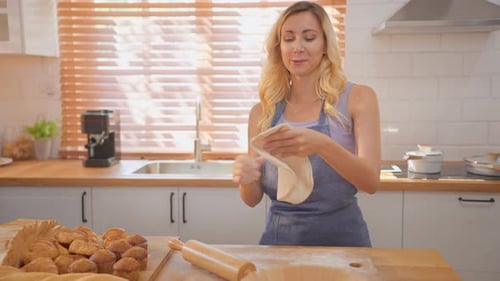 Caucasian woman kneaded yeast dough with hands in kitchen at home.