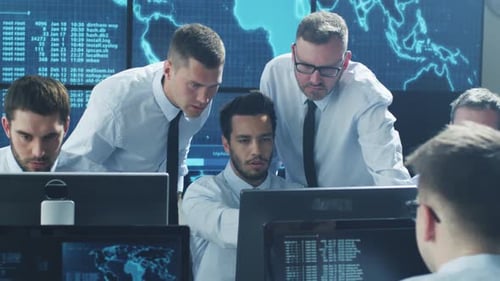 Team IT Security Professional Working in Bright Monitoring Room Filled with Displays