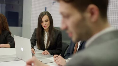 Corporate Team Deep in Discussion During Business Meeting