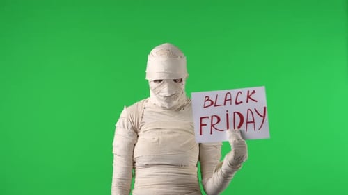 Green Screen Isolated Chroma Key Video Capturing a Mummy Raising Two Pieces of Paper with 50 Percent
