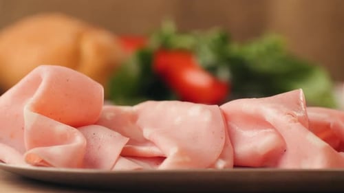 Close up of Sliced Bologna with Bread and Salad