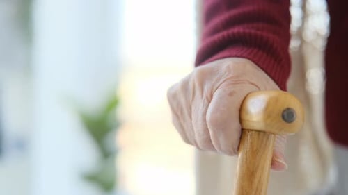 Senior Person's Hand Gripping a Walking Cane